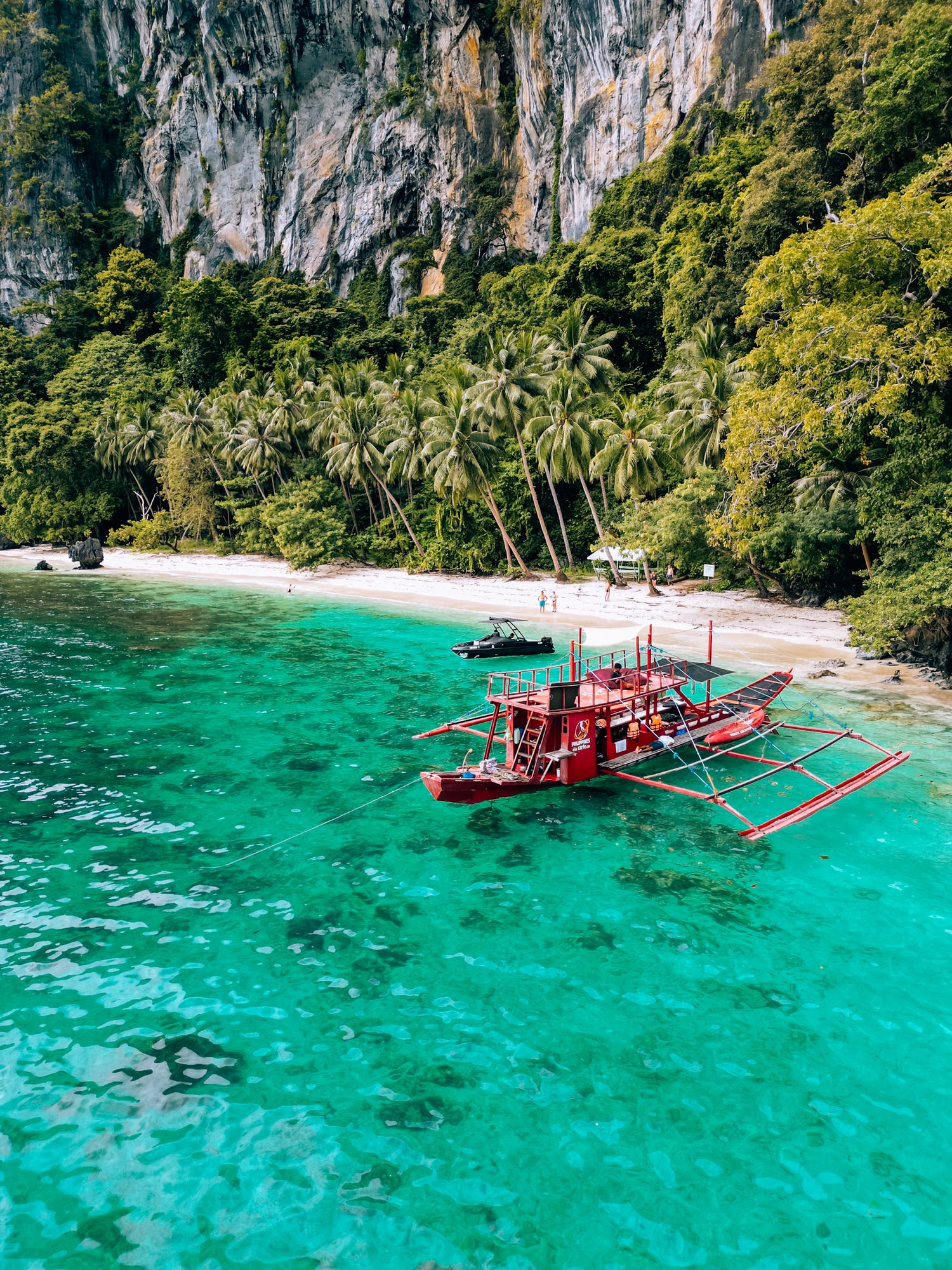 Traditional outrigger boat in crystal clear tropical water enhanced with FS Travel Photography Lightroom Presets.