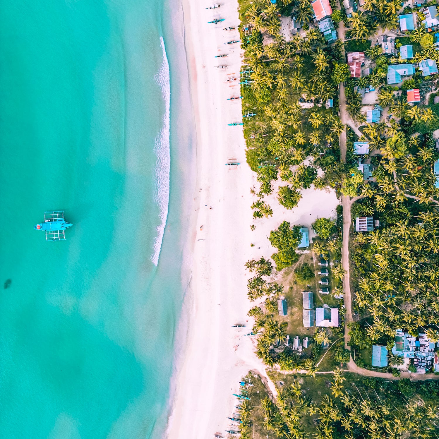 Drone photo of a tropical beach with turquoise water edited using FS Travel Photography Presets